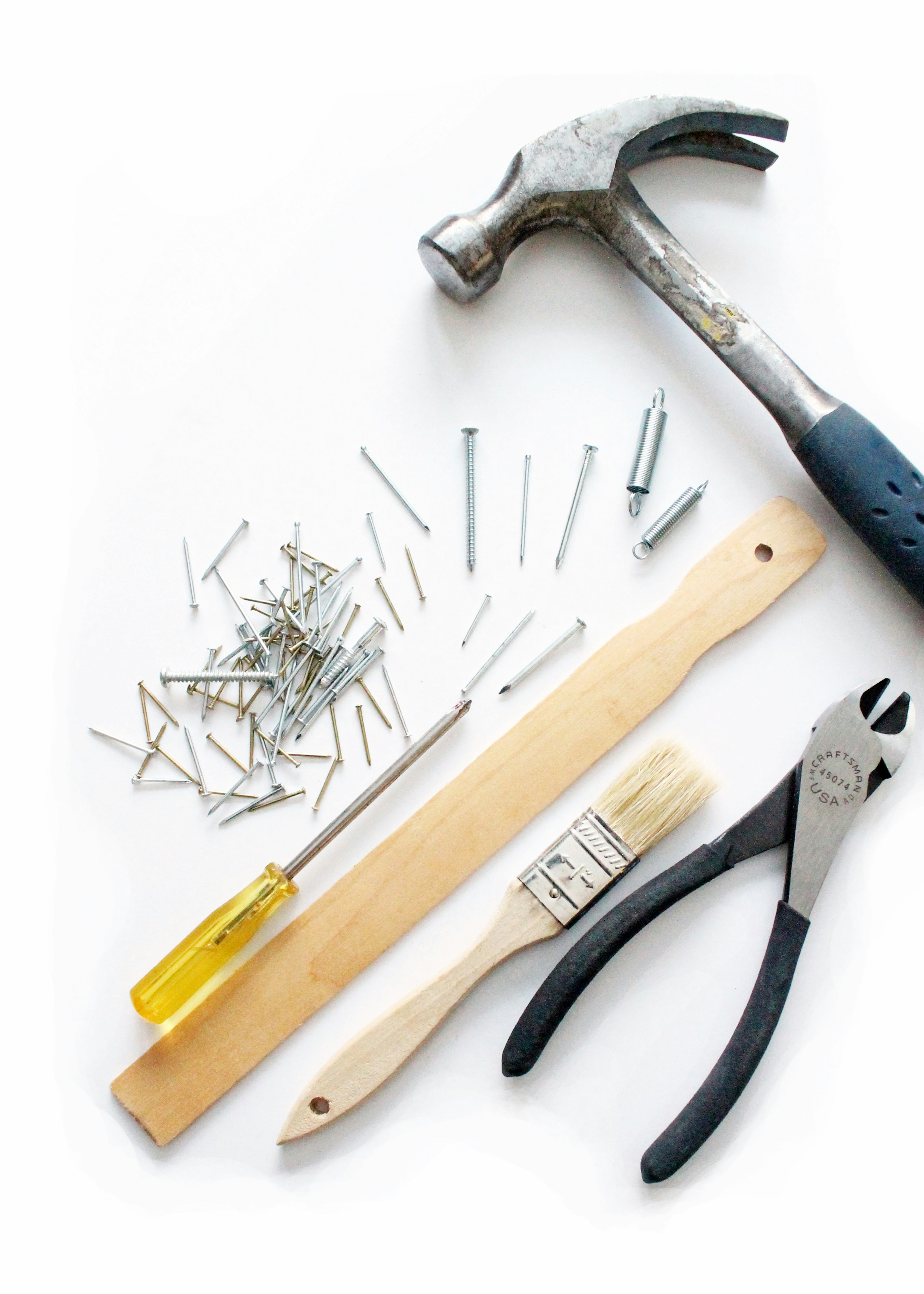 Hammer, nails and other construction tools on white background, BerkleyNet blog post about the risks of misclassified NCCI class codes in workers compensation insurance. 