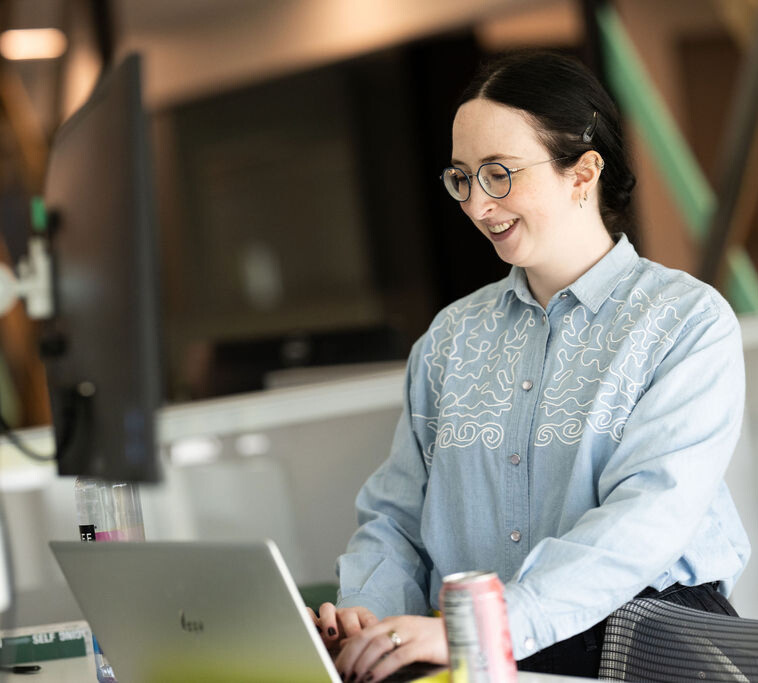 BerkleyNet employee working on computer in the BerkleyNet, workers compensation insurance, office. 