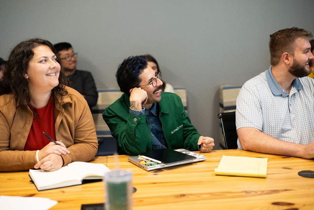 WC Policy Premium Audit Three BerkleyNet employees sitting at a desk in the BerkleyNet, workers compensation insurance, office.