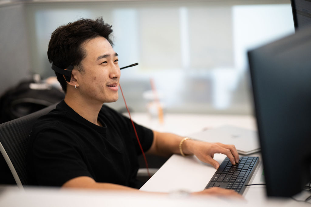 Man working on a computer at his desk, using BerkleyNet digital tools and resources for managing workers compensation insurance.
